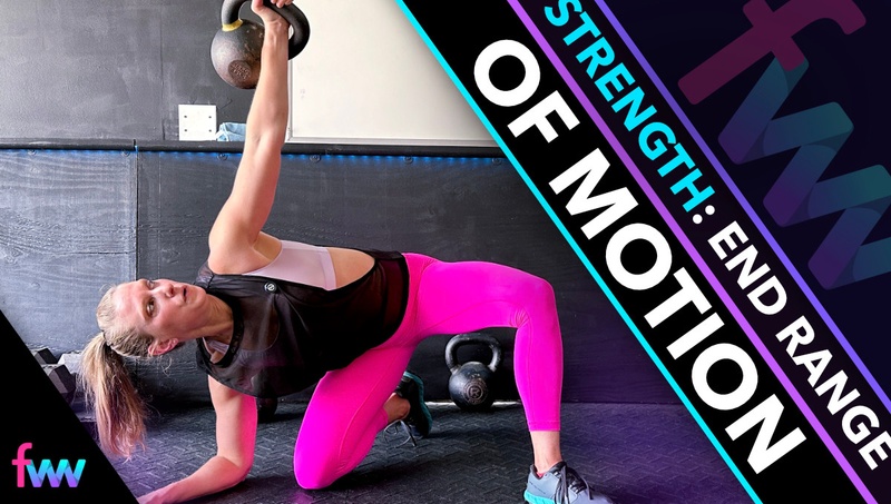 Kindal at the bottom of a forearm kneeling windmill pushing her hip mobility.