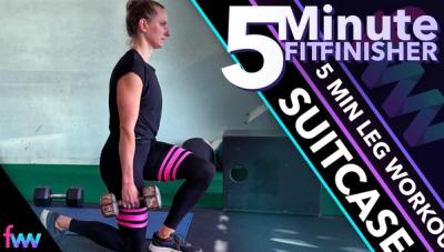 Kindal holding a dumbbell suitcase style in a narrow lunge. She is testing her ab stability and balance while working out her legs.