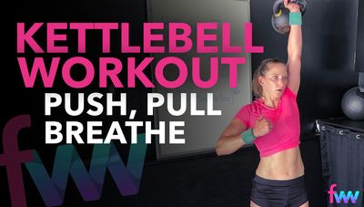 Kindal extending the kettlebell over her head during a clean to press.