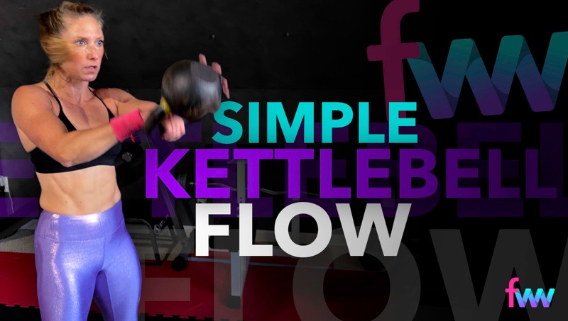 Kindal at the top of a kettlebell swing locking her body out and hitting the swing hard.