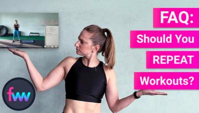 Kindal holding a workout from FWW LIVE and looking at it wondering if she should repeat the workout tor not.