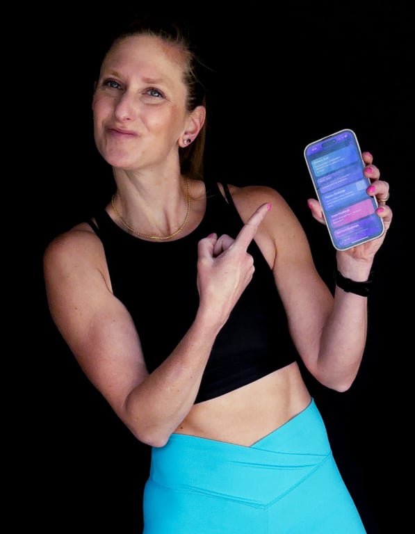 Kindal in s deep side kettlebell side lunge working her way through an intense metabolic strength workout.