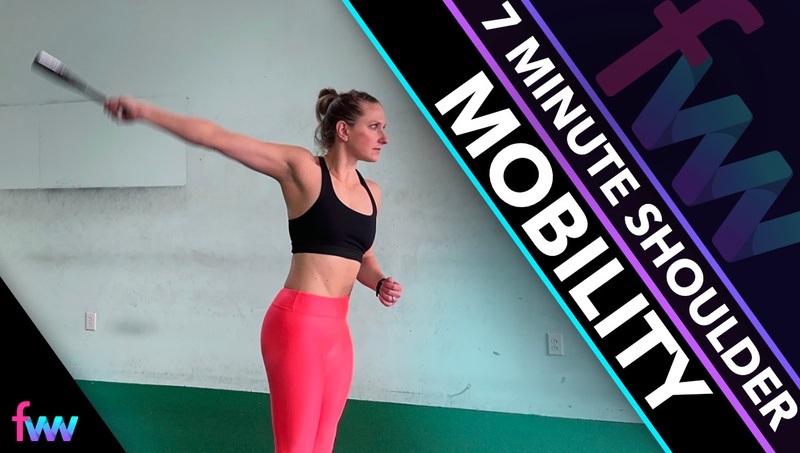 Kindal doing shoulder circles with a weighted club to help mobilize her shoulder joint and take it through her full range of motion.