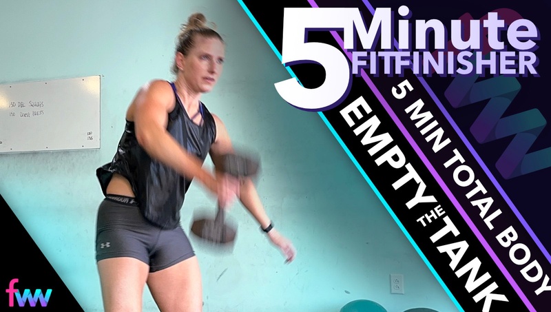 Kindal about midway through the dumbbell floor snatch. Her elbow has stopped moving and she is letting the weight travel up so she can then press it overhead.