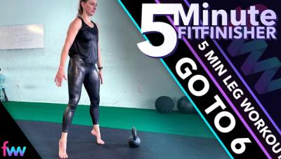 Kindal at the top of a squat hop on her tip toes.