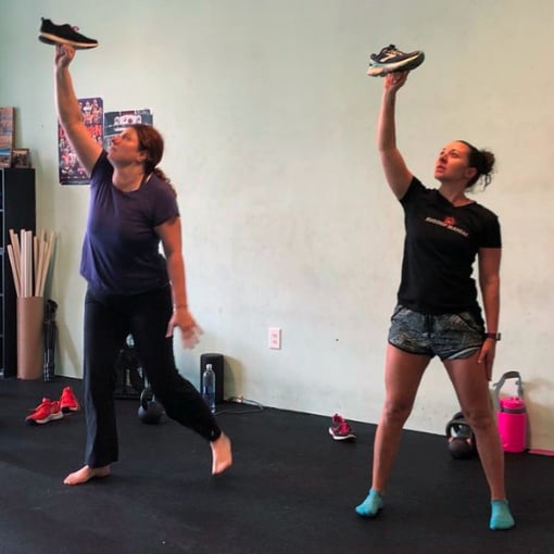 Studio clients learning how to do the kettlebell getup