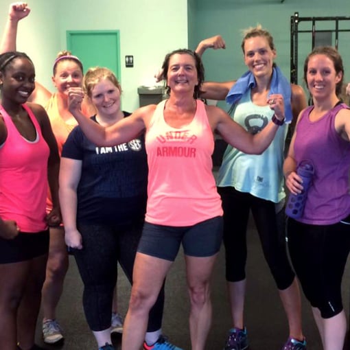 Studio clients flexing after a tough workout