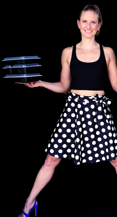 Kindal holding a bunch of healthy meals she has cooked