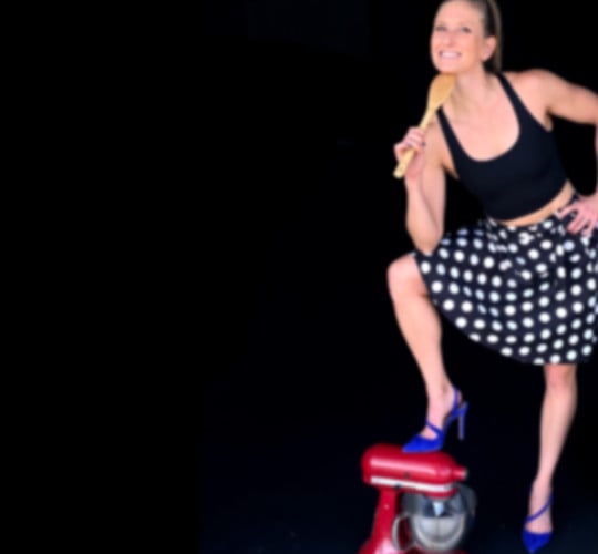 Kindal with a cooking spoon and foot on blender